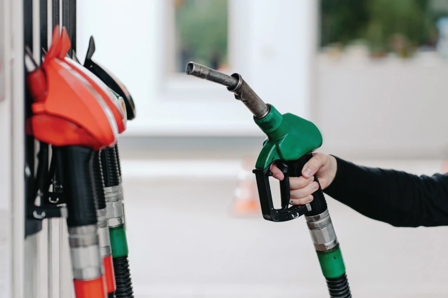 hand holding a green petrol pump