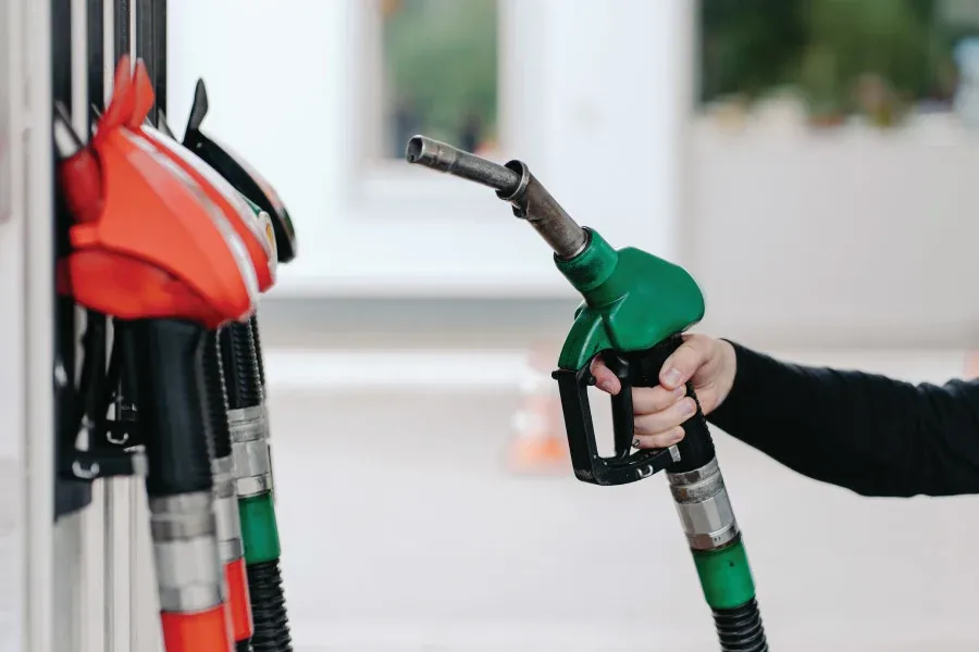 hand holding a green petrol pump